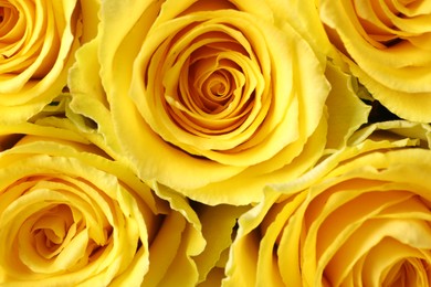 Photo of Beautiful bouquet of yellow roses as background, top view