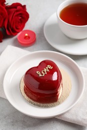 Photo of St. Valentine's Day. Delicious heart shaped cake served on light table