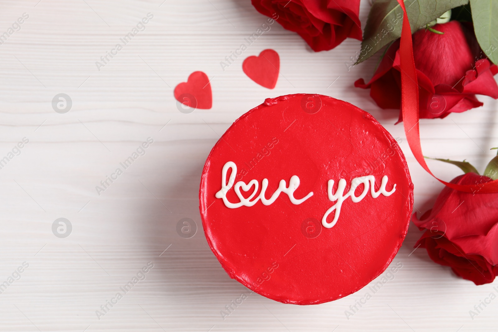 Photo of Bento cake with text Love You, roses, paper hearts and space for text on white wooden table, flat lay. St. Valentine's day surprise