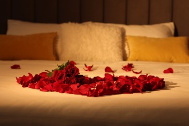 Photo of Honeymoon. Roses and beautiful petals on bed