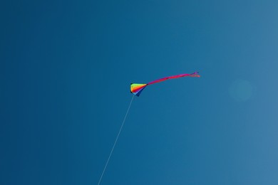 Photo of One colorful kite flying in blue sky