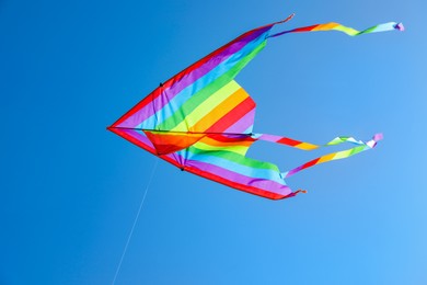 Photo of One colorful kite flying in blue sky
