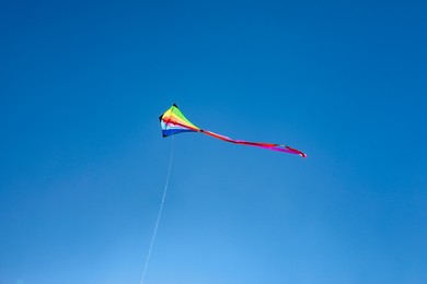 Photo of One colorful kite flying in blue sky