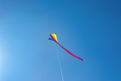 Photo of One colorful kite flying in blue sky