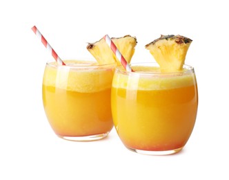 Photo of Tasty pineapple cocktail in glasses isolated on white