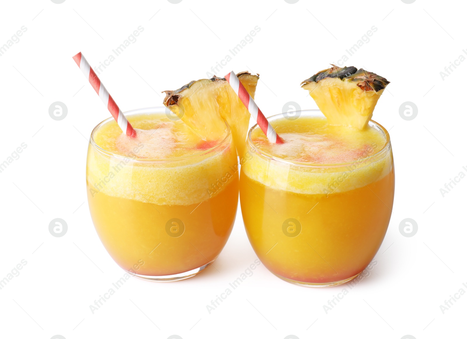 Photo of Tasty pineapple cocktail in glasses isolated on white