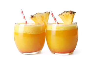 Photo of Tasty pineapple cocktail in glasses isolated on white