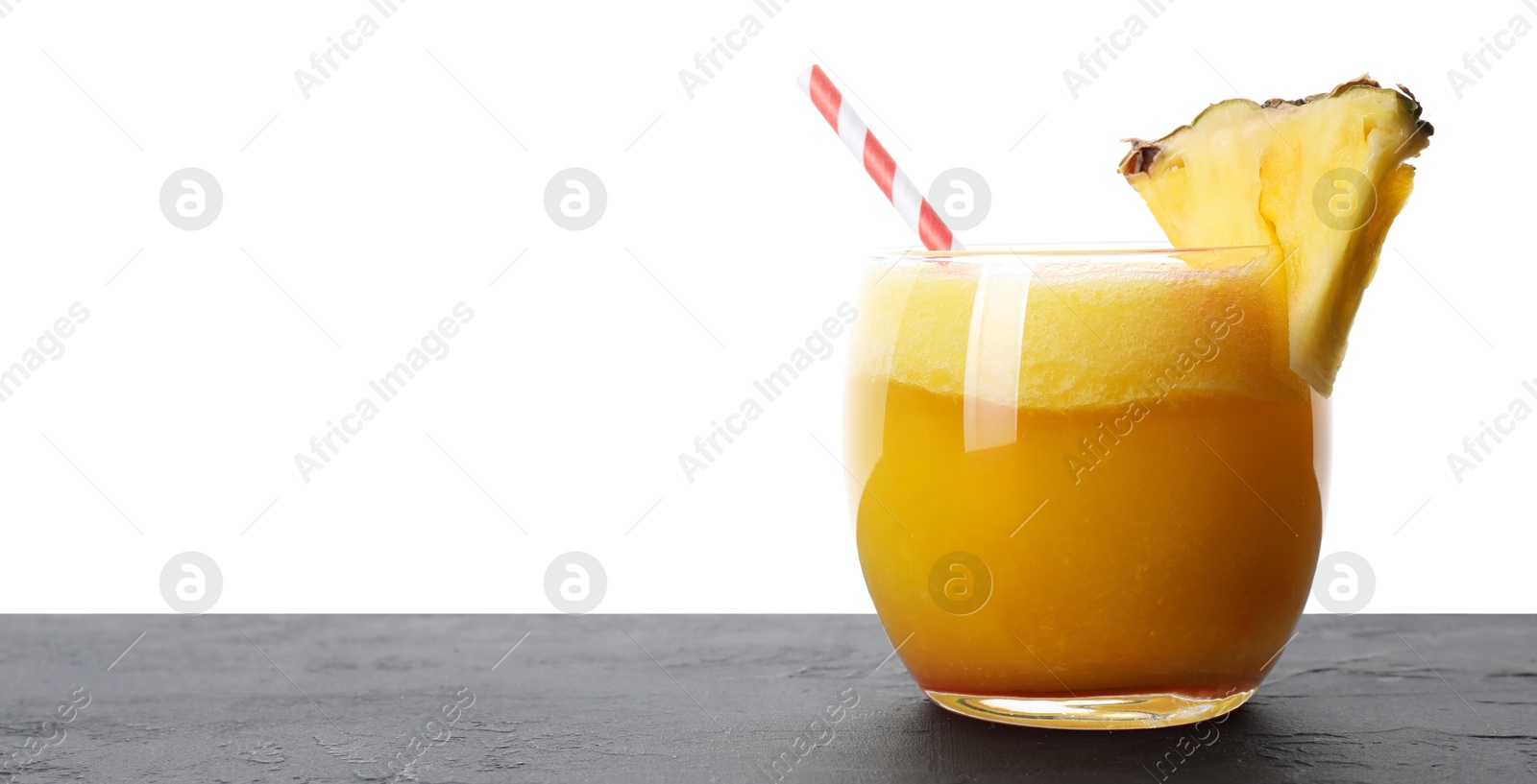 Photo of Tasty pineapple cocktail in glass on black table against white background