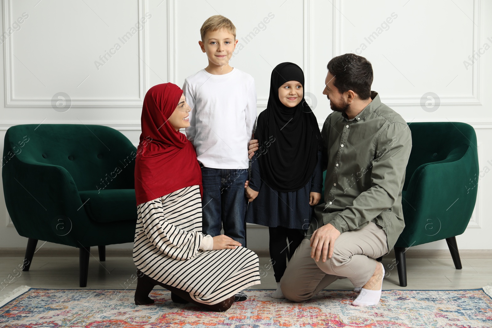 Photo of Happy Muslim family spending time together at home