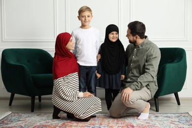 Photo of Happy Muslim family spending time together at home