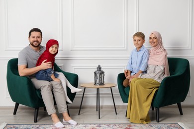 Photo of Happy Muslim family spending time together at home