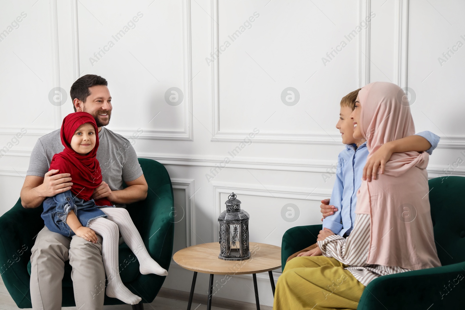 Photo of Happy Muslim family spending time together at home