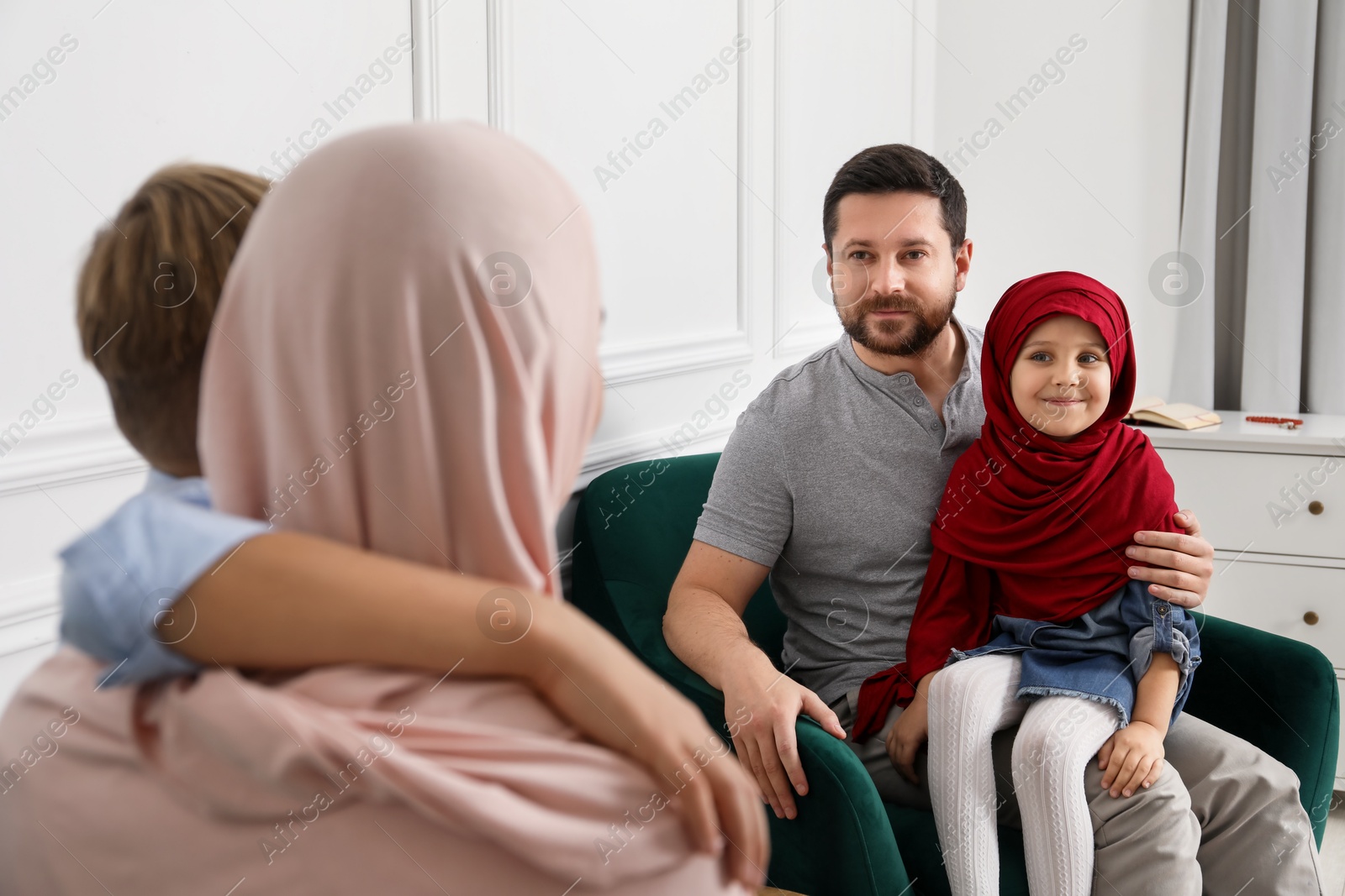 Photo of Happy Muslim family spending time together at home