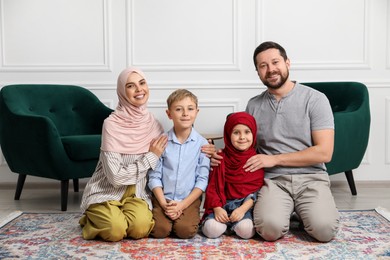 Photo of Happy Muslim family spending time together at home