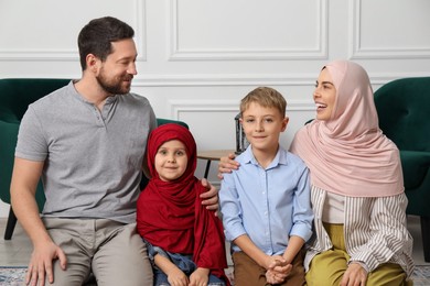 Happy Muslim family spending time together at home