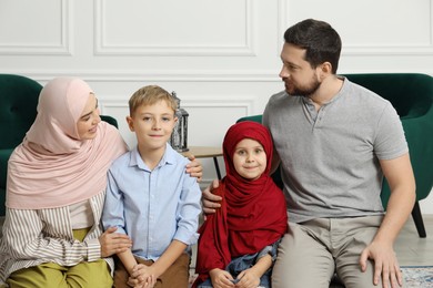 Photo of Happy Muslim family spending time together at home