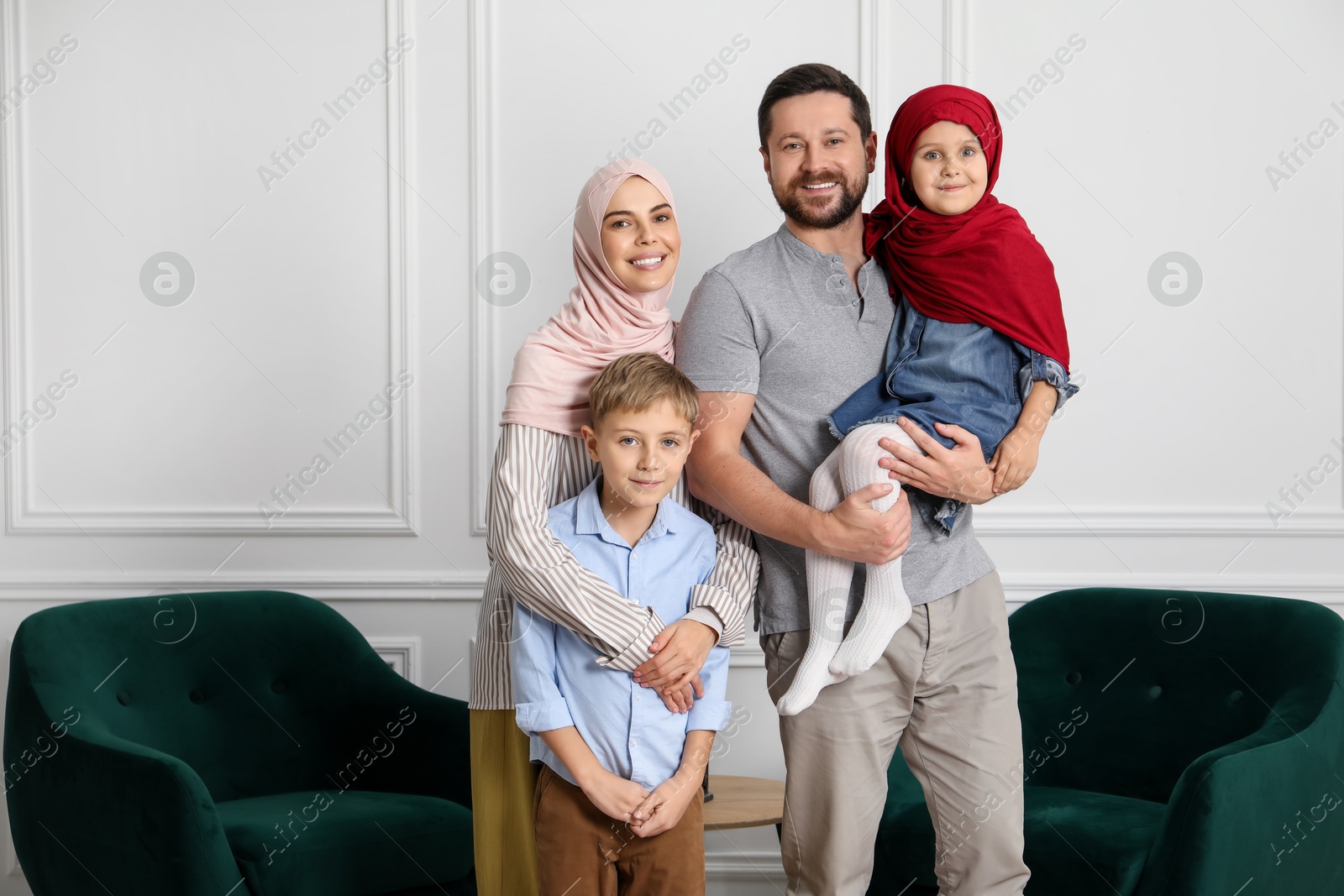 Photo of Happy Muslim family spending time together at home