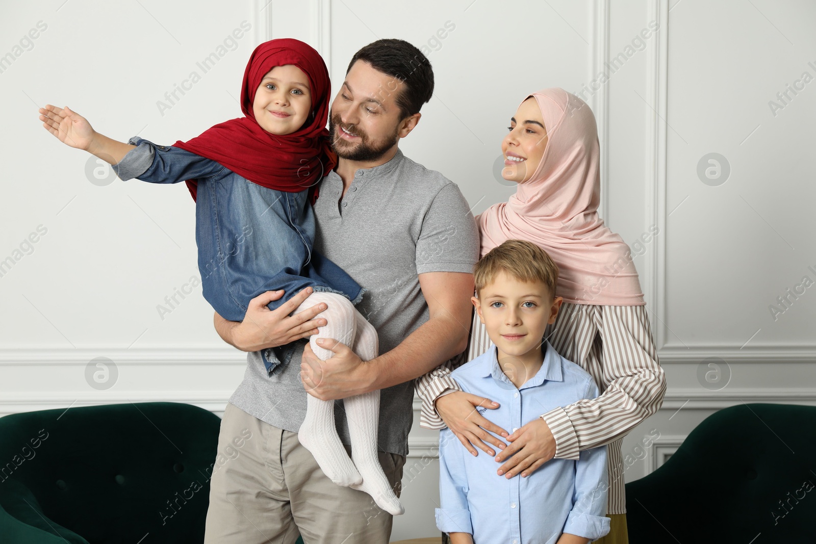 Photo of Happy Muslim family spending time together at home