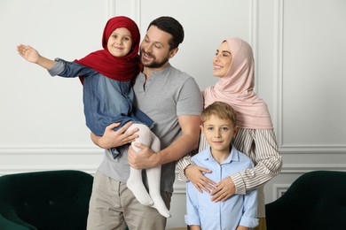 Photo of Happy Muslim family spending time together at home