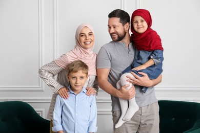 Happy Muslim family spending time together at home