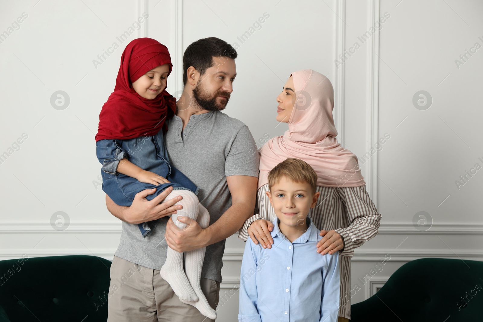 Photo of Happy Muslim family spending time together at home