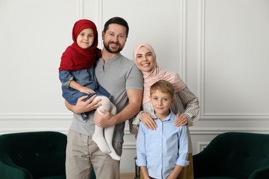 Photo of Happy Muslim family spending time together at home