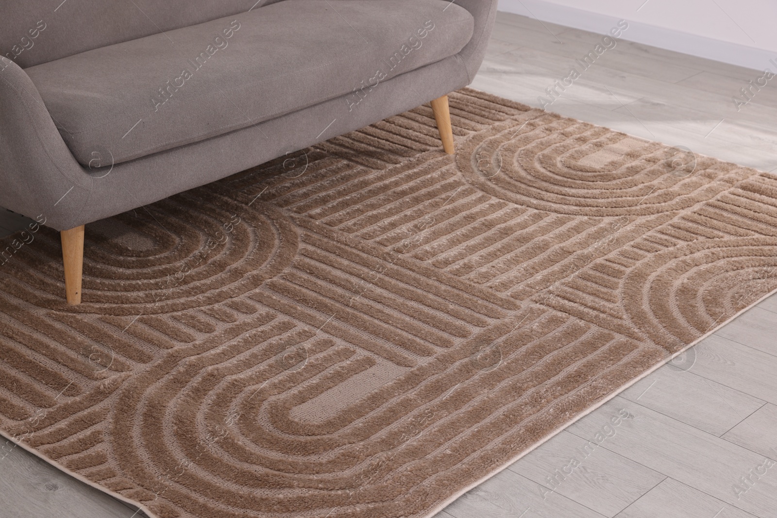 Photo of Stylish soft rug with pattern on floor indoors