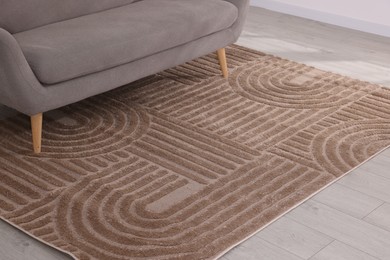Photo of Stylish soft rug with pattern on floor indoors