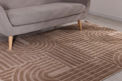 Photo of Stylish soft rug with pattern on floor indoors