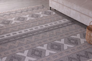 Photo of Stylish soft rug with pattern on floor indoors