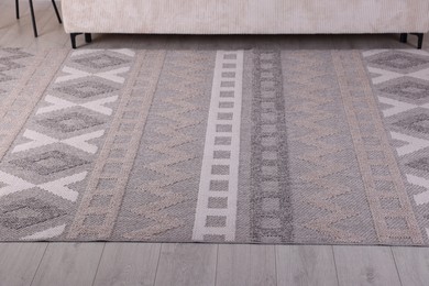 Photo of Stylish soft rug with pattern on floor indoors