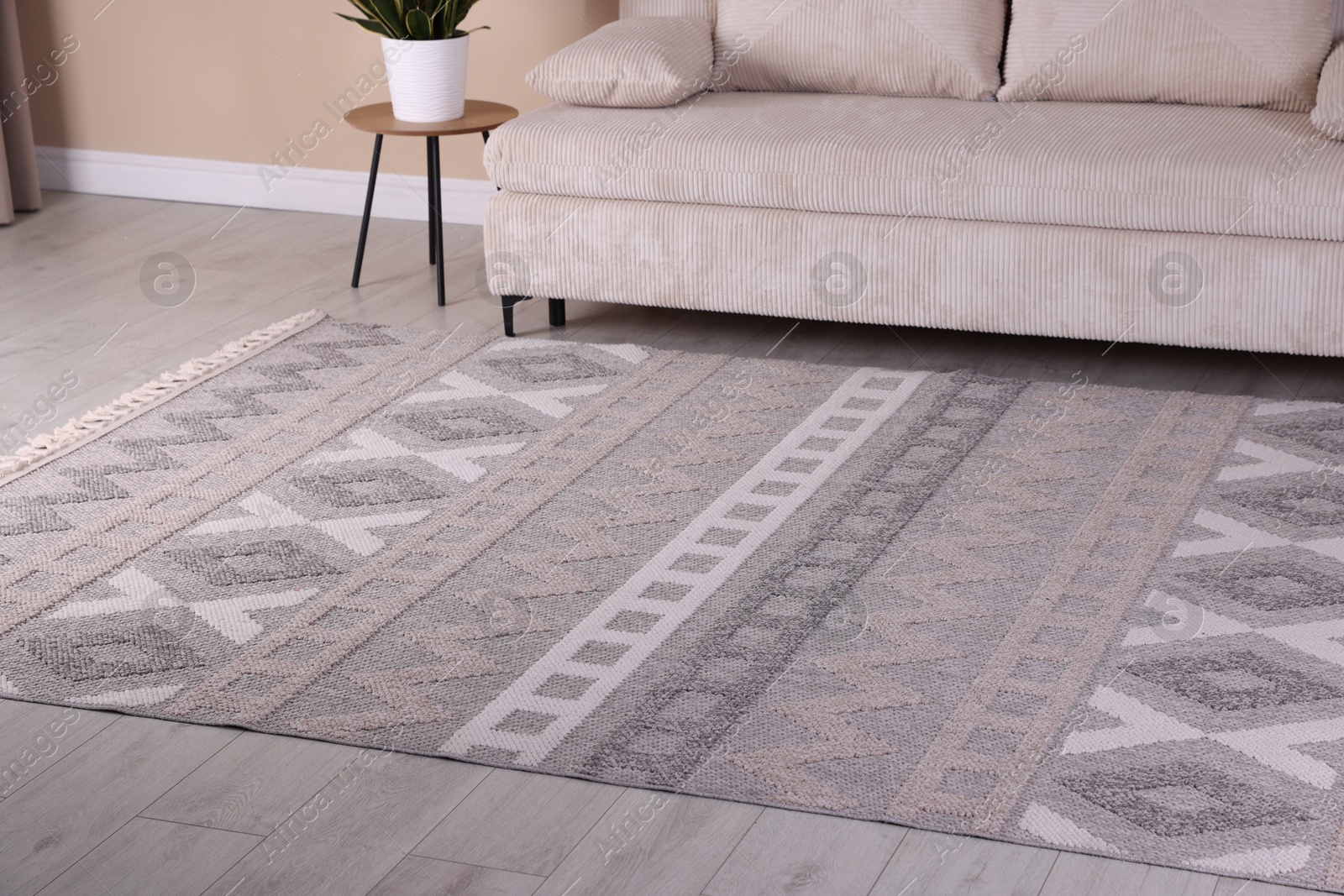 Stylish soft rug with pattern on floor indoors Photo of Stylish soft rug with pattern on floor indoors