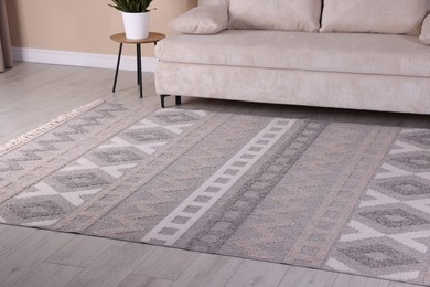 Photo of Stylish soft rug with pattern on floor indoors
