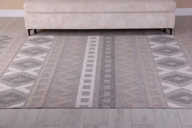 Photo of Stylish soft rug with pattern on floor indoors