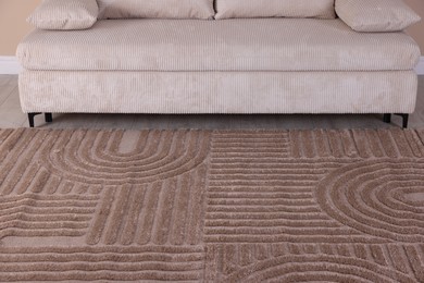 Photo of Stylish soft rug with pattern on floor indoors