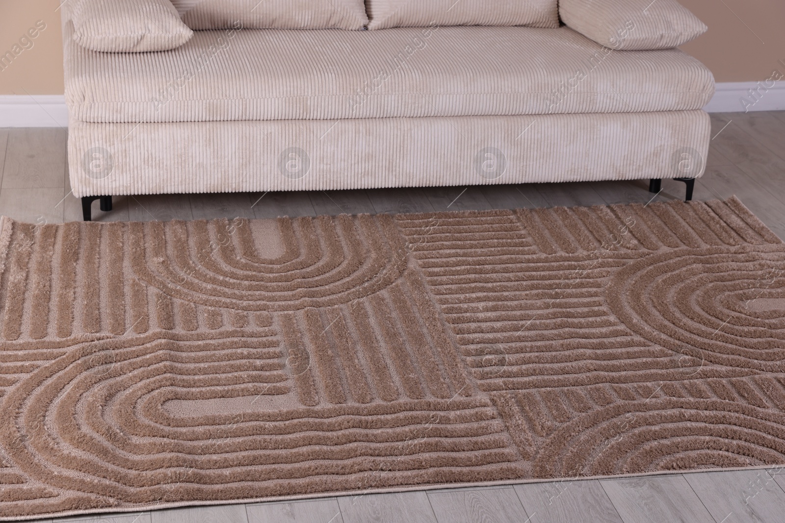 Photo of Stylish soft rug with pattern on floor indoors