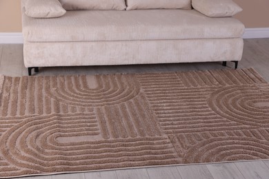Photo of Stylish soft rug with pattern on floor indoors