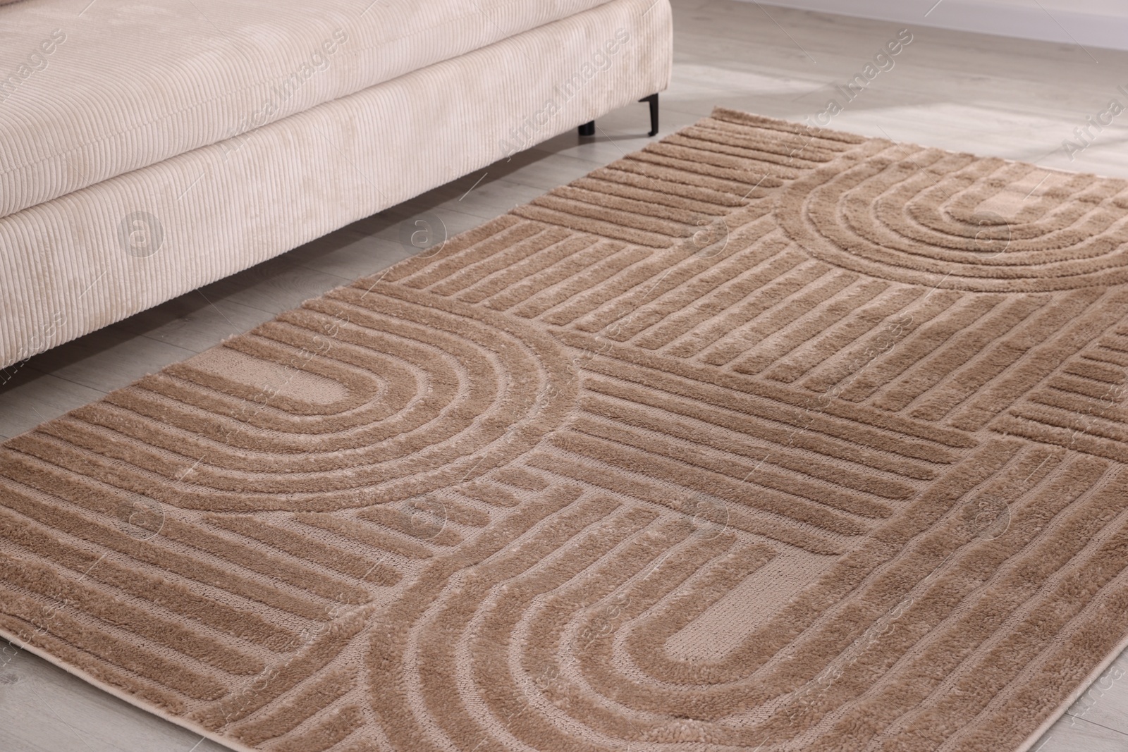 Stylish soft rug with pattern on floor indoors Photo of Stylish soft rug with pattern on floor indoors