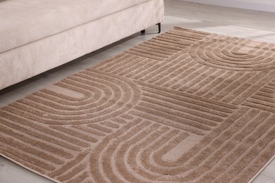 Photo of Stylish soft rug with pattern on floor indoors