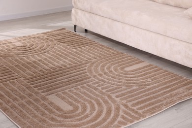 Photo of Stylish soft rug with pattern on floor indoors