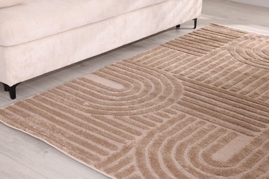 Photo of Stylish soft rug with pattern on floor indoors