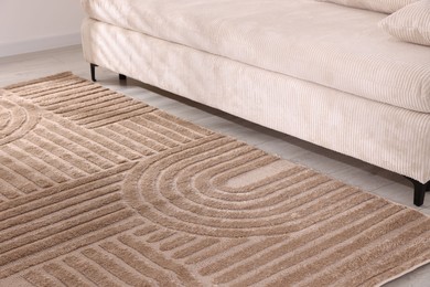Photo of Stylish soft rug with pattern on floor indoors