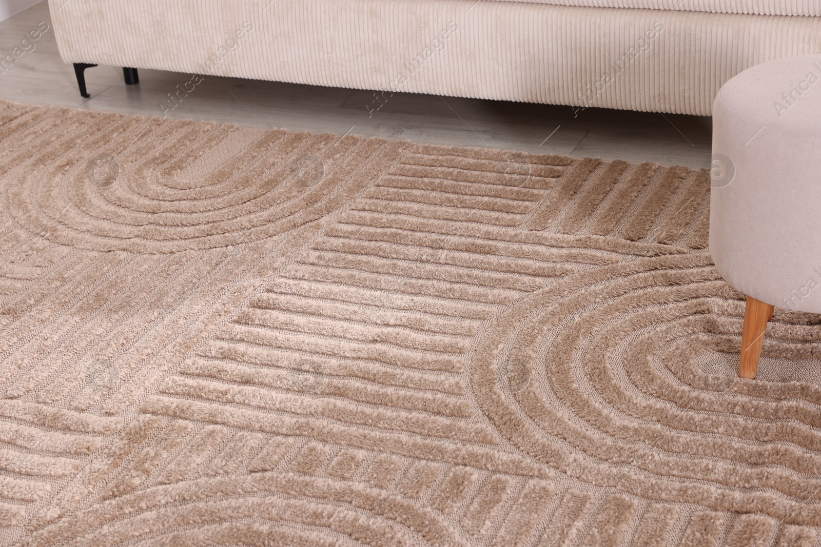 Photo of Stylish soft rug with pattern on floor indoors