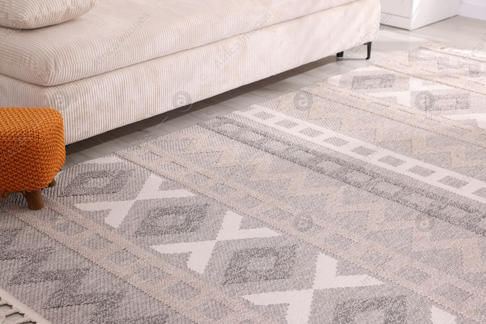 Photo of Stylish soft rug with pattern on floor indoors
