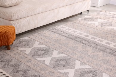 Photo of Stylish soft rug with pattern on floor indoors