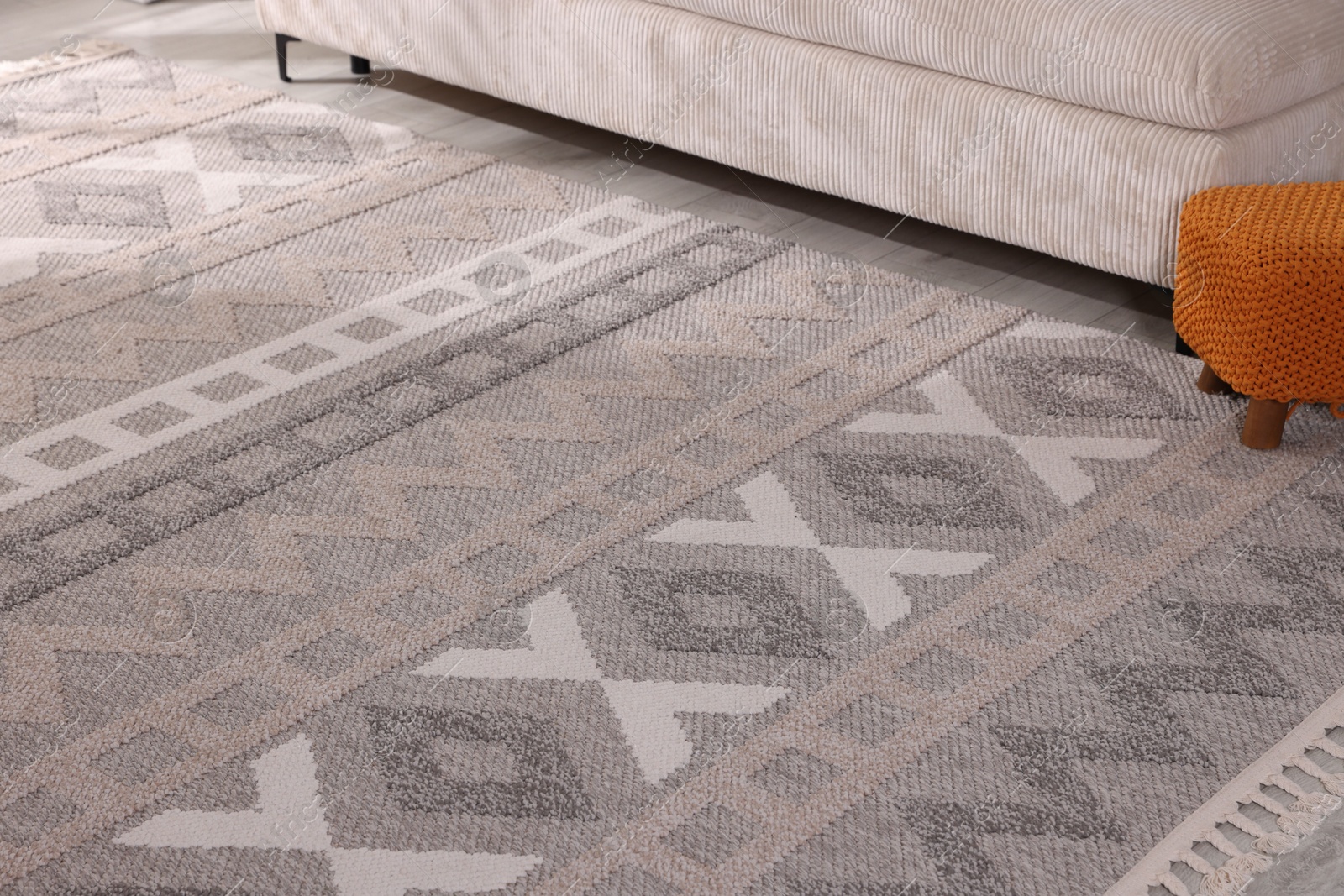 Photo of Stylish soft rug with pattern on floor indoors
