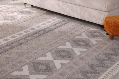 Photo of Stylish soft rug with pattern on floor indoors