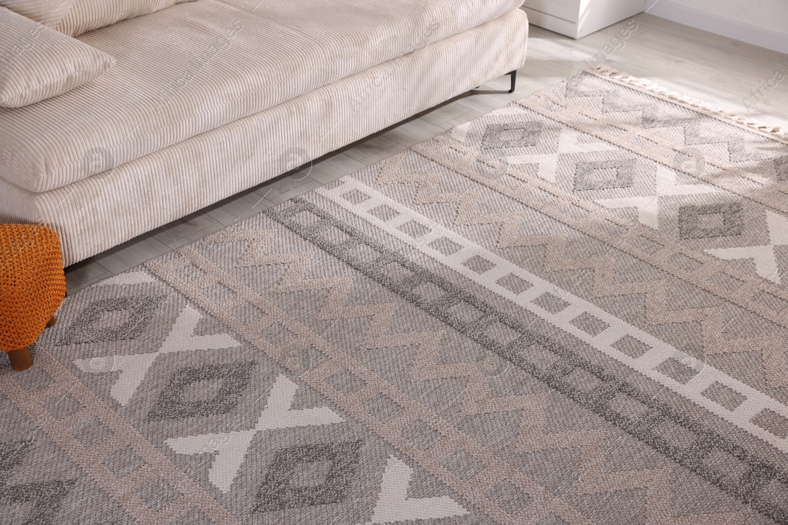 Stylish soft rug with pattern on floor indoors Photo of Stylish soft rug with pattern on floor indoors