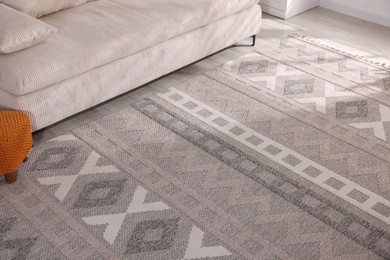 Photo of Stylish soft rug with pattern on floor indoors