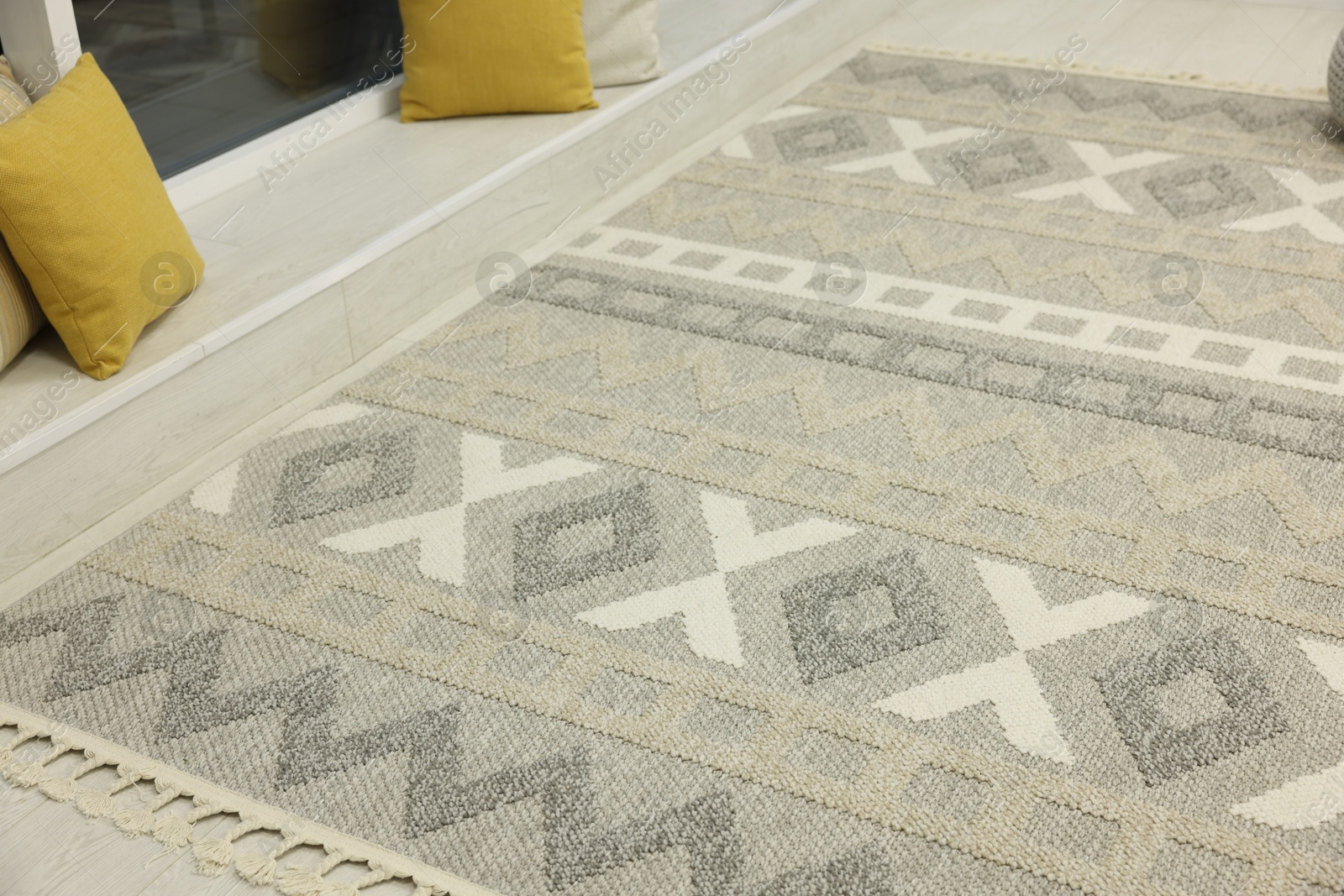 Stylish rug with pattern on floor indoors Photo of Stylish rug with pattern on floor indoors